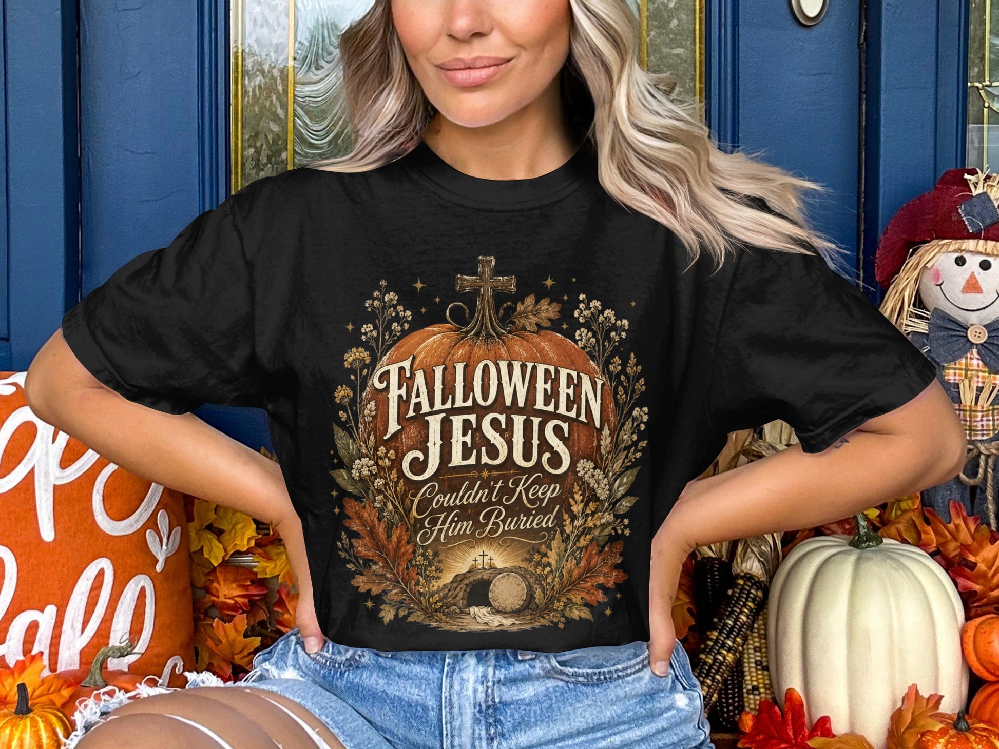 Black t-shirt with "Halloween Jesus Couldn't Keep Him Buried" text and tomb graphic.
