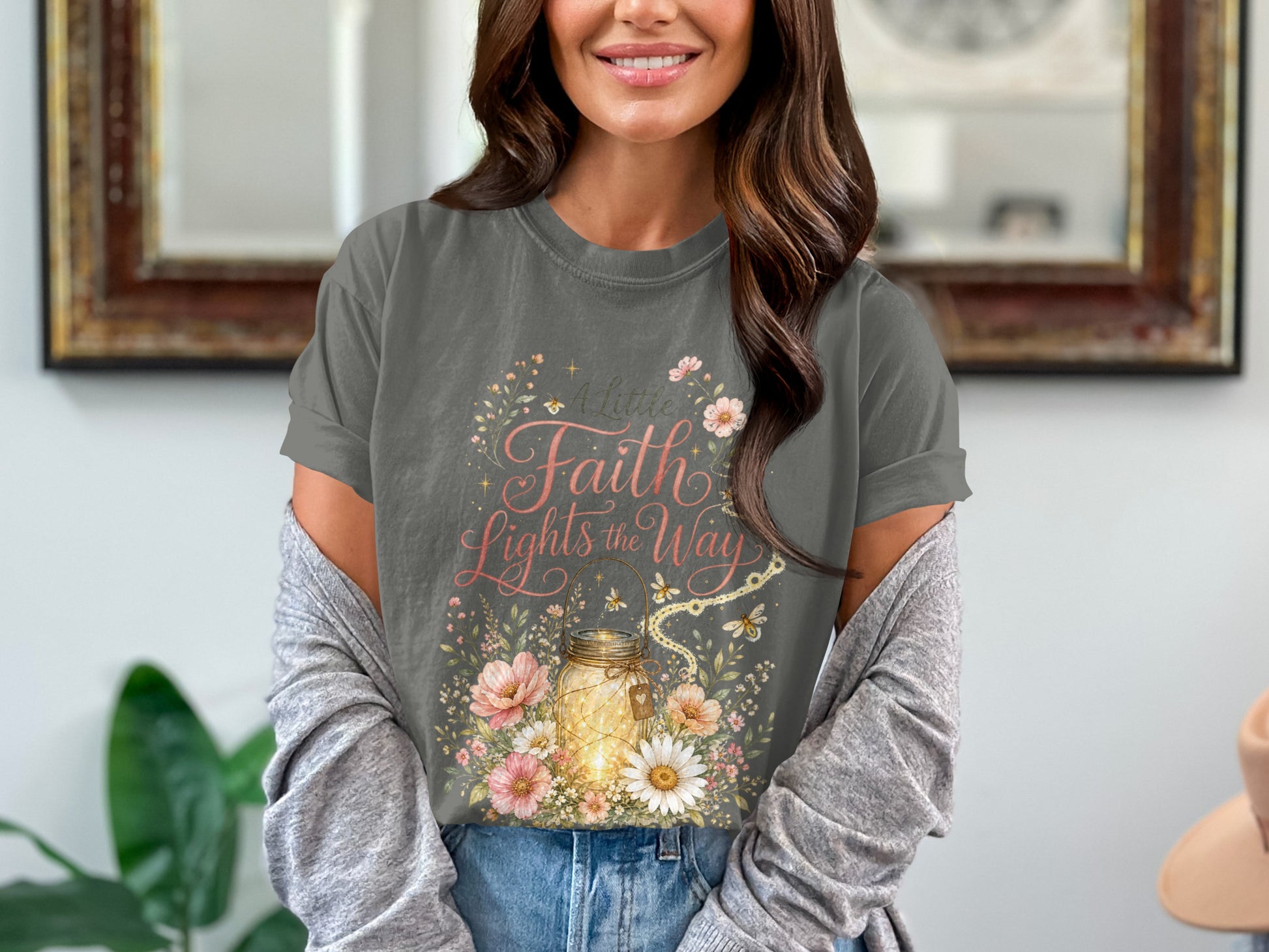 "A Little Faith Lights the Way" graphic on a dark grey t-shirt with a mason jar and flowers.
