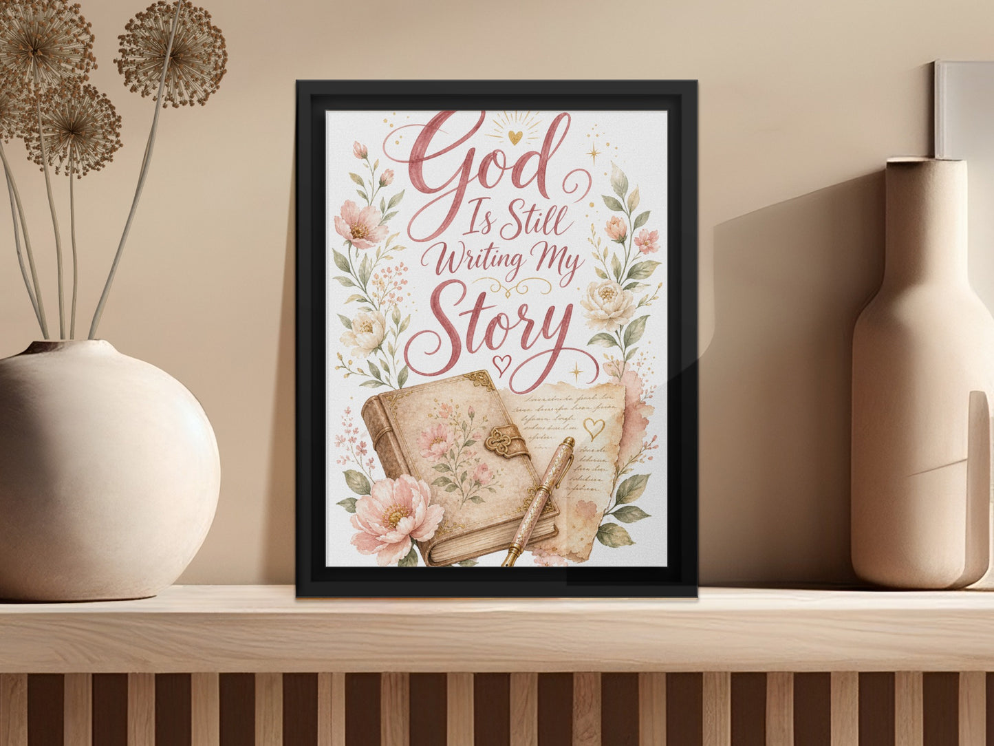 Framed artwork with quote "God Is Still Writing My Story" and floral accents.