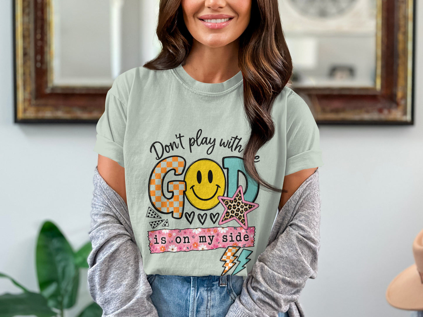 Light green t-shirt with "Don't play with GOD is on my side" graphic.