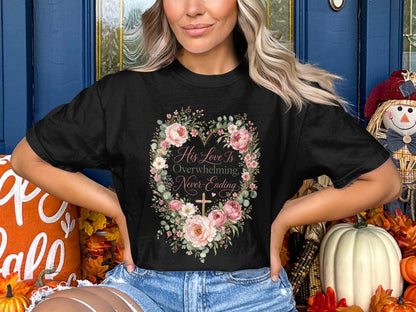 Black t-shirt with floral heart, cross, and text "His Love Is Overwhelming, Never-Ending."