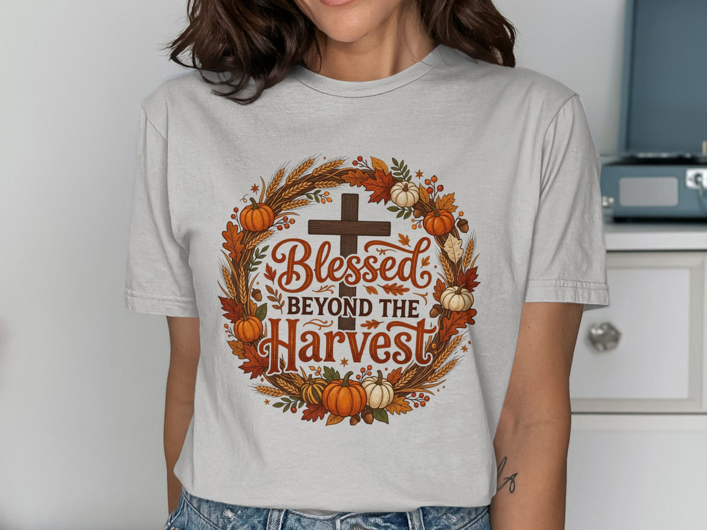 "Blessed Beyond the Harvest" text on a wreath of wheat, pumpkins, and leaves.