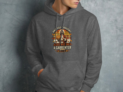 Dark grey hoodie with "And you thought Jesus was only a carpenter" text and pumpkin graphic.