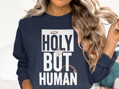 Navy sweatshirt with "HOLY BUT HUMAN" text and halo graphic.