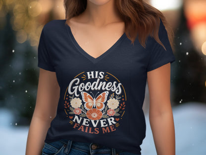 Navy v-neck t-shirt with butterfly and floral graphic: "His Goodness Never Fails Me."
