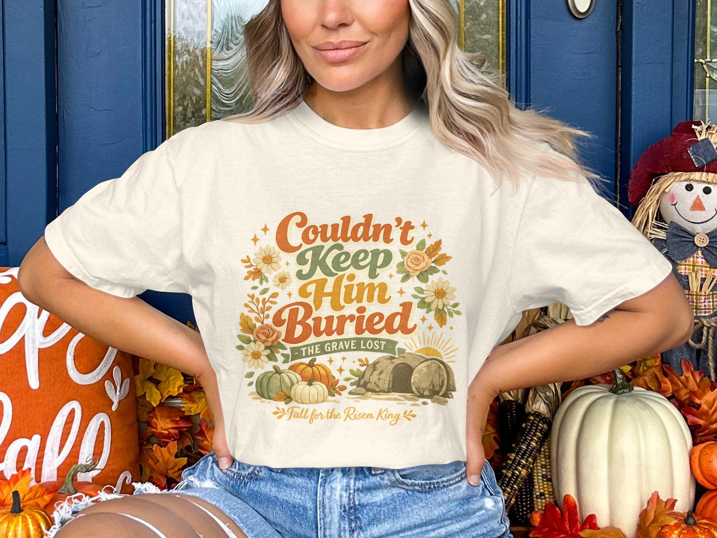 Cream t-shirt with "Couldn't Keep Him Buried" graphic featuring pumpkins and a tomb.