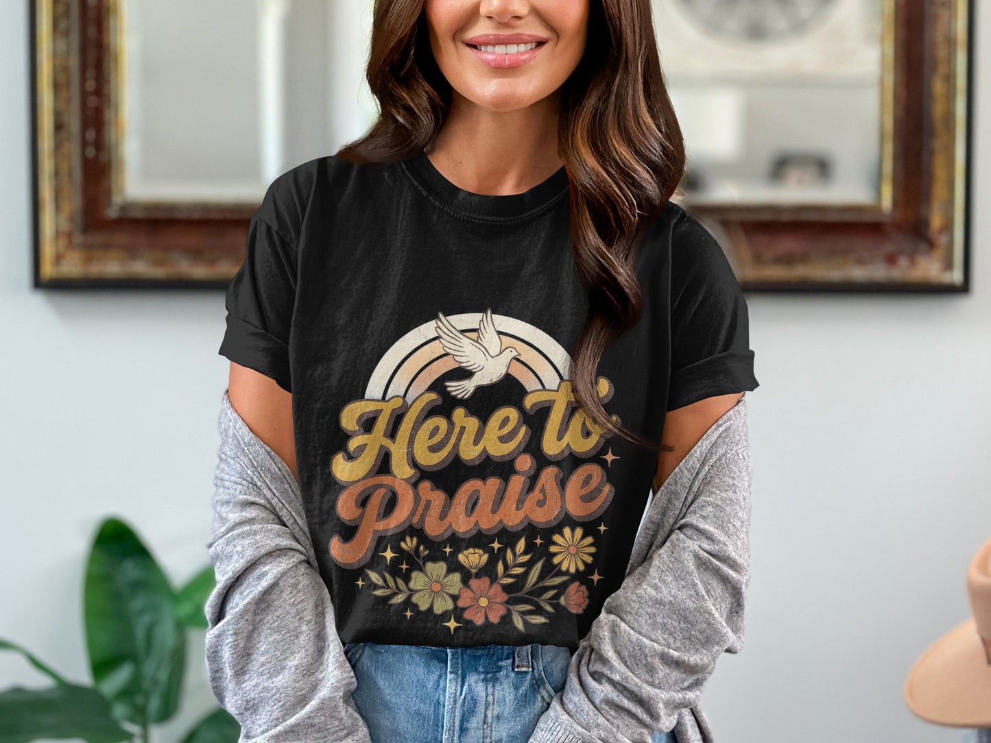Black t-shirt with "Here to Praise" text, rainbow, dove, and floral design.