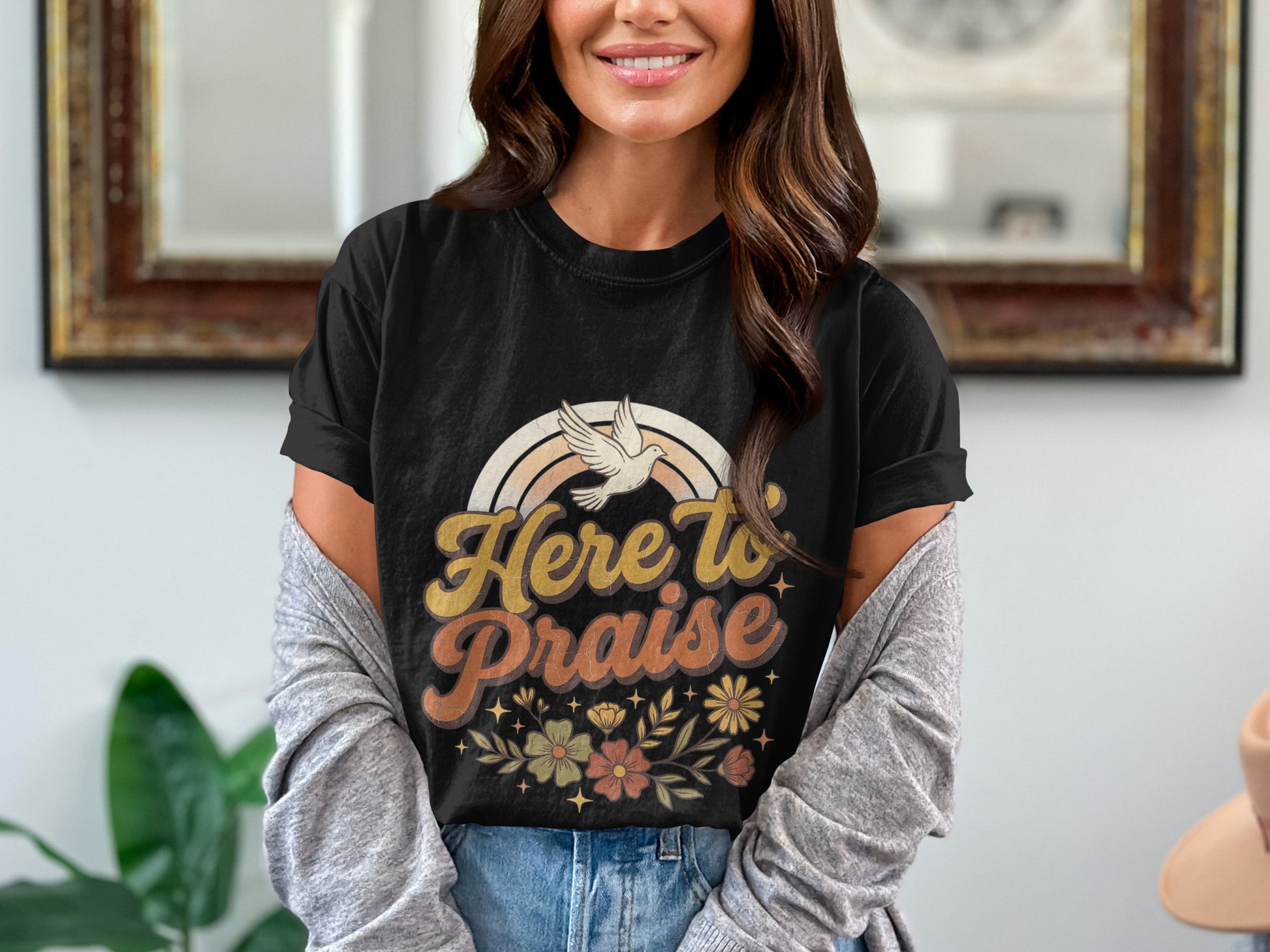 Black t-shirt with "Here to Praise" text, rainbow, dove, and floral design.