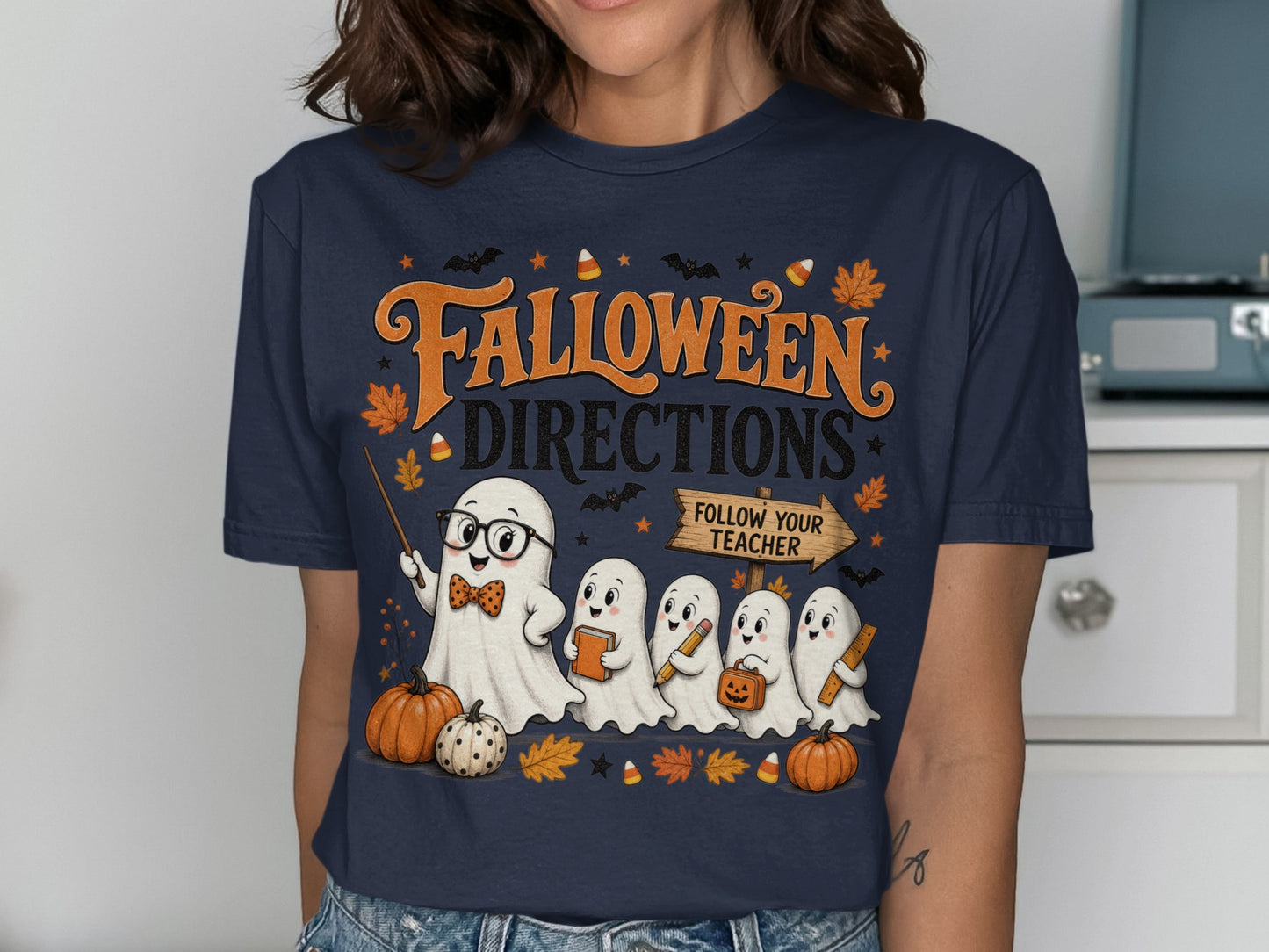 "Halloween Directions" text with ghosts and pumpkins on a dark blue t-shirt.
