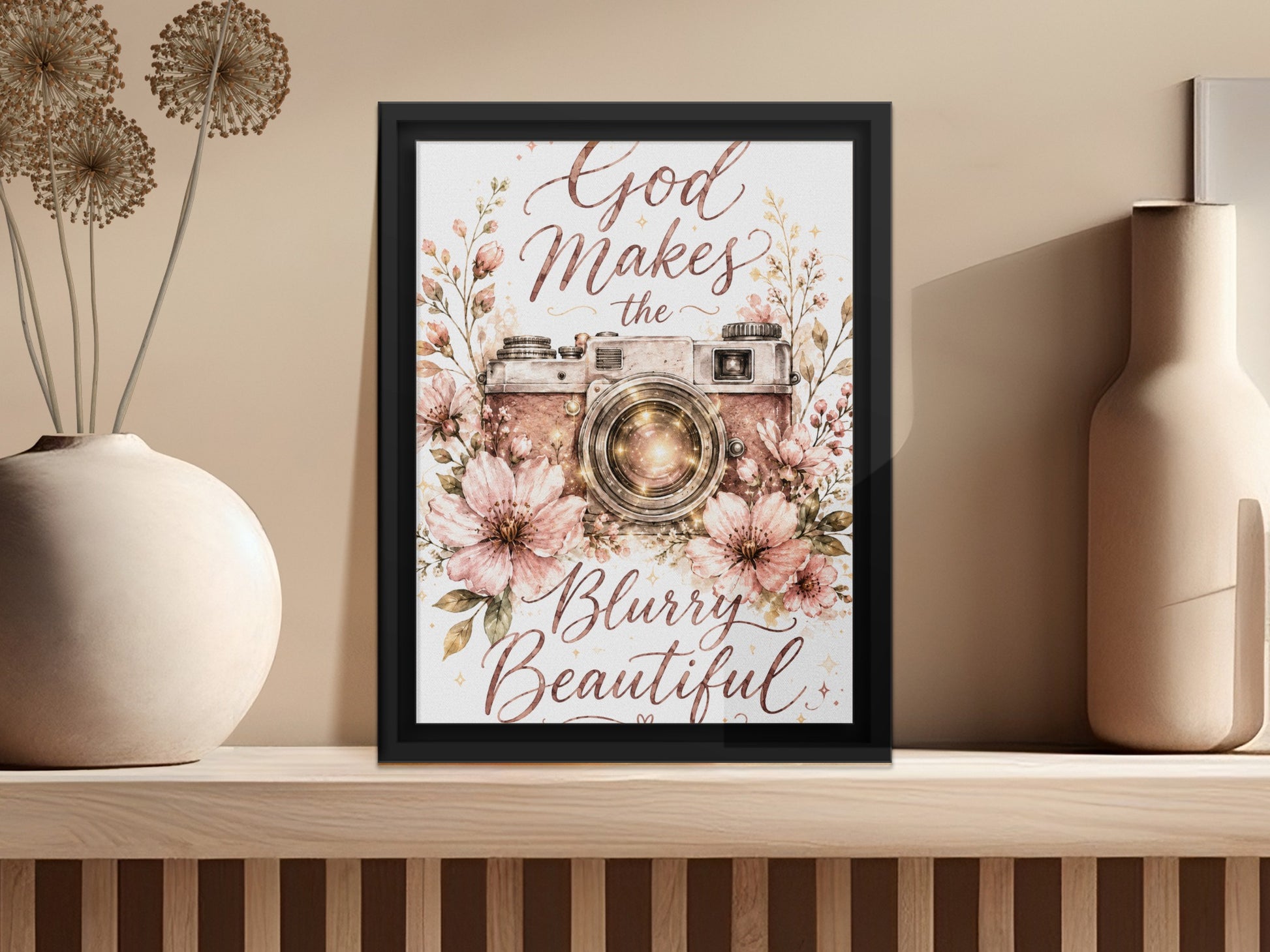 Framed artwork with a vintage camera, flowers, and text "God Makes the Blurry Beautiful."