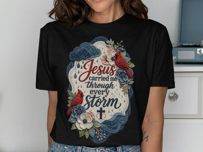 Black t-shirt with "Jesus carried me through every storm" text and floral design.
