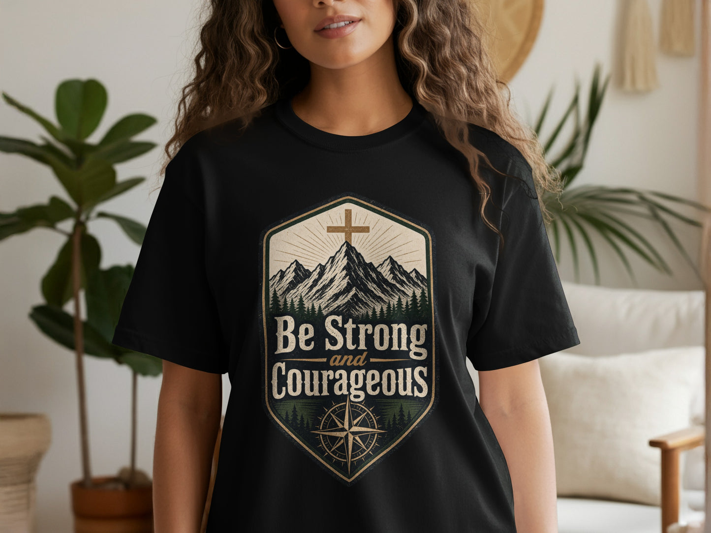 Black t-shirt with "Be Strong and Courageous" text in a mountain scene.
