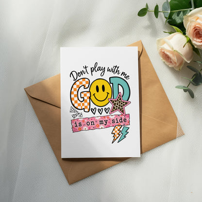 Card with "Don't play with me GOD is on my side" and smiley face.