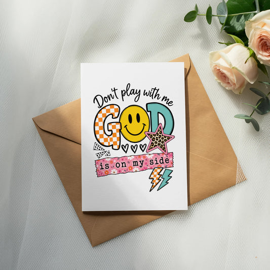 Card with "Don't play with me GOD is on my side" and smiley face.