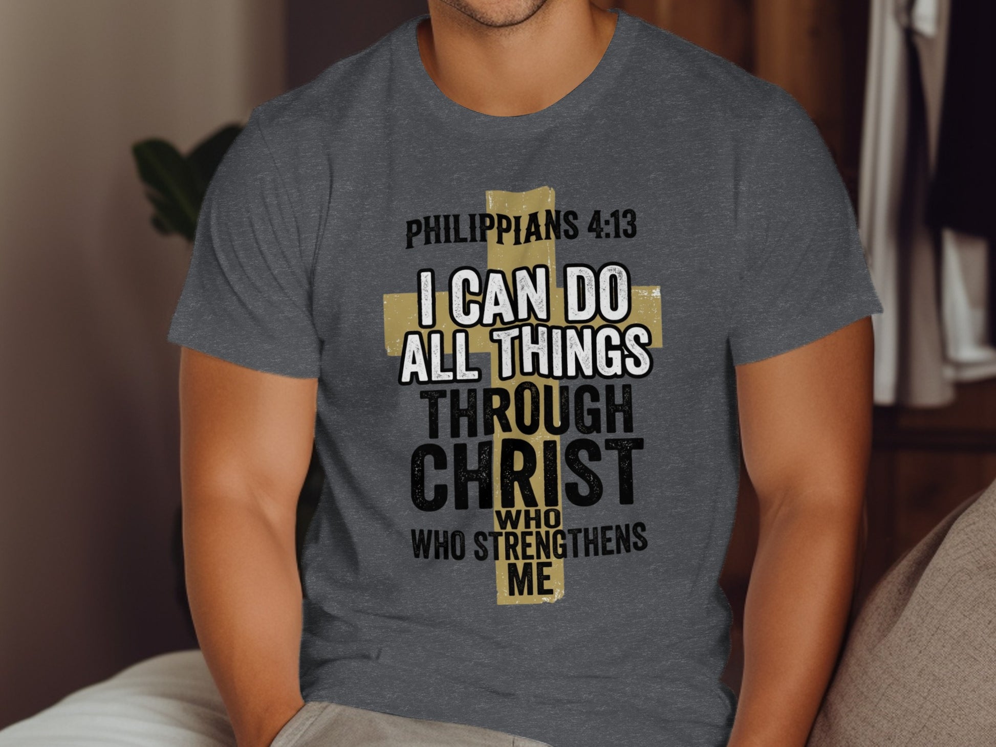 Philippians 4:13 text on a gray t-shirt across a person's chest.