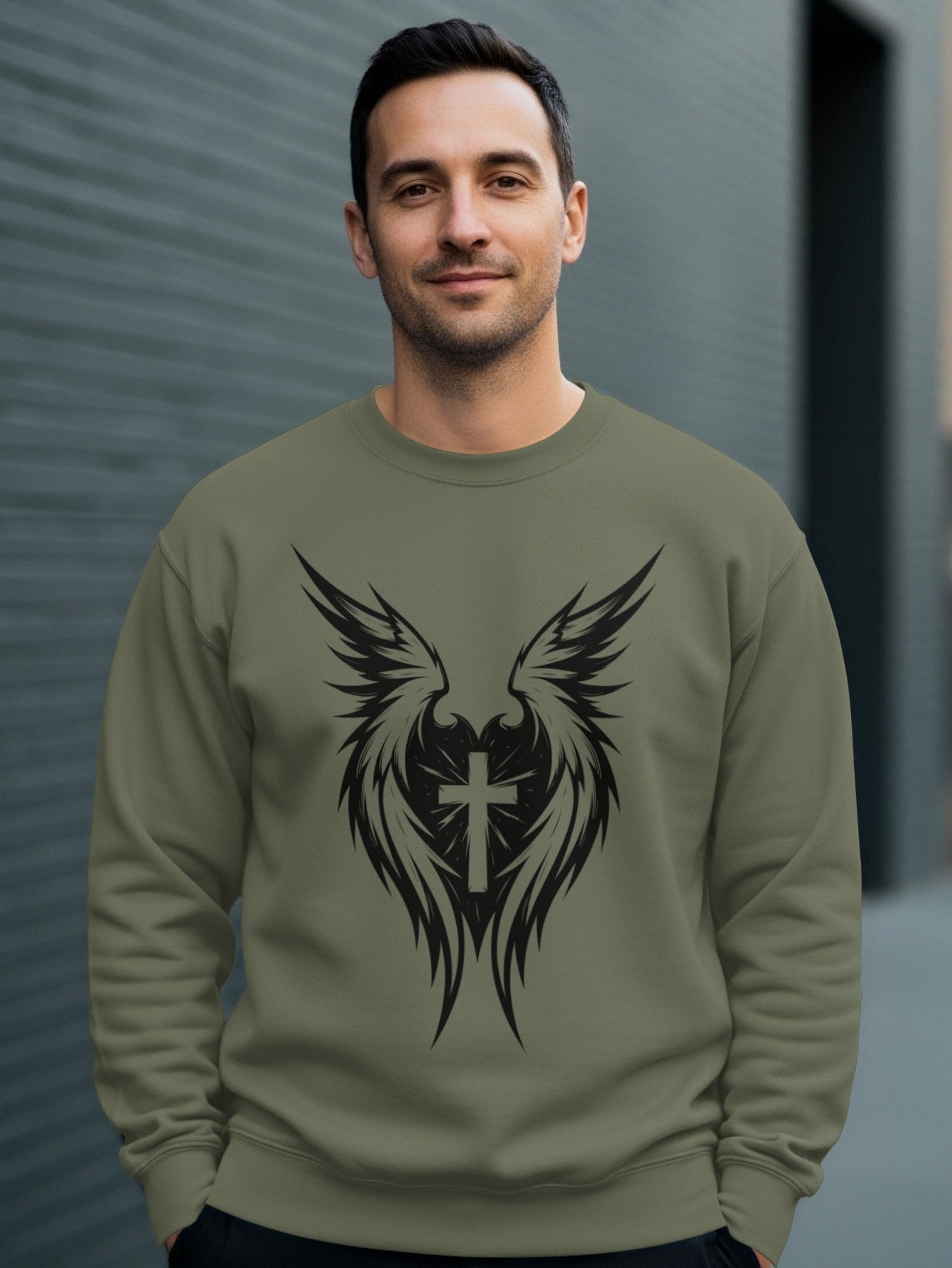 Green sweatshirt with black cross and wings graphic on chest.