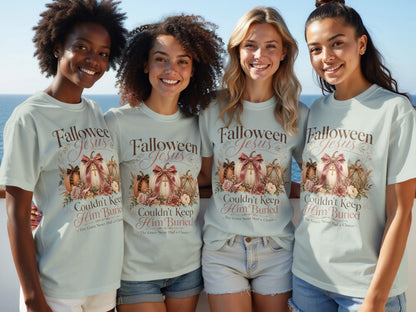 Four women wear light blue t-shirts with pumpkins and text that says "Falloween Jesus Couldn't Keep Him Buried".