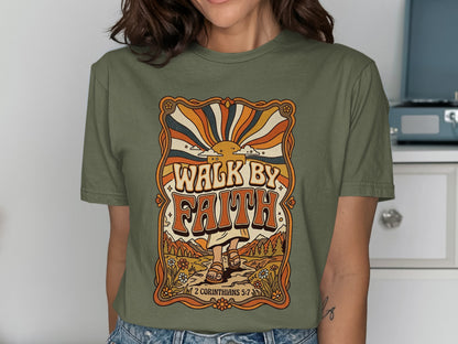 Olive green t-shirt with "Walk by Faith" text and retro sunset graphic.