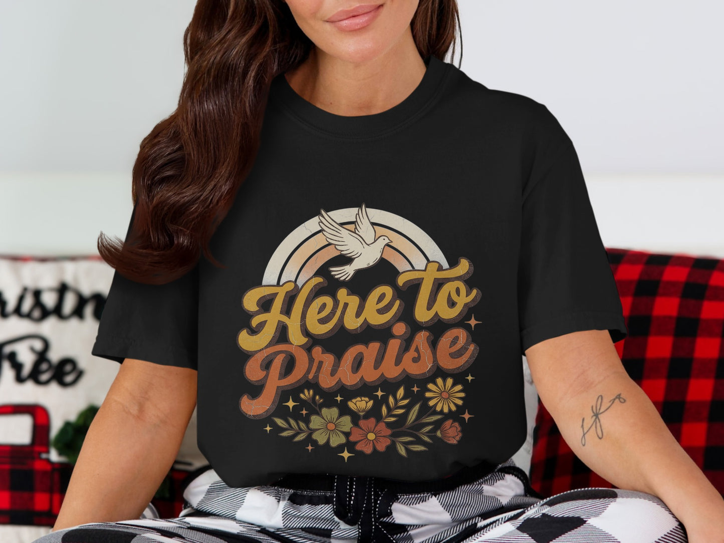 Black t-shirt with "Here to Praise" text, dove, rainbow, and floral design.
