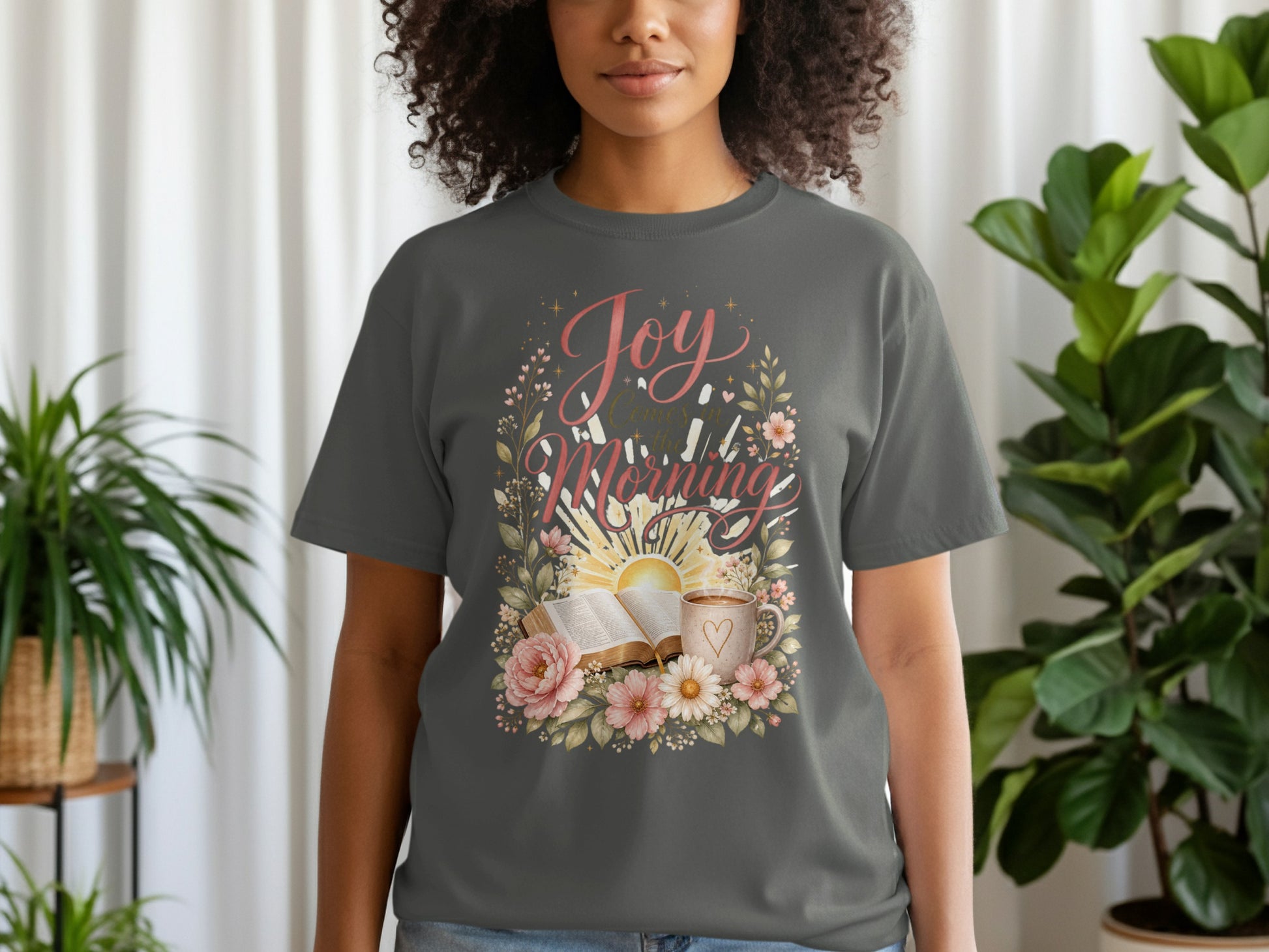 Dark grey t-shirt with "Joy Comes in the Morning" floral design featuring sun, book, and coffee.