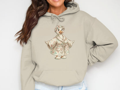 Beige hoodie with a cartoon duck wearing a floral robe.