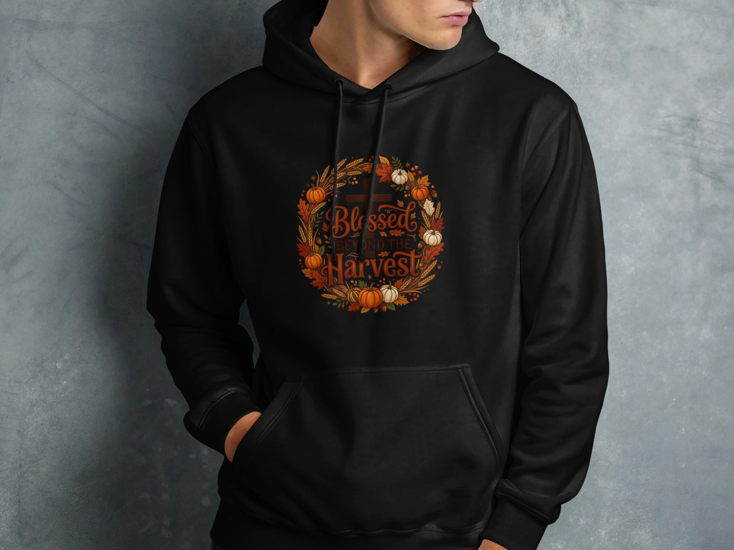 Black hoodie with "Blessed Beyond the Harvest" text and autumn wreath graphic.