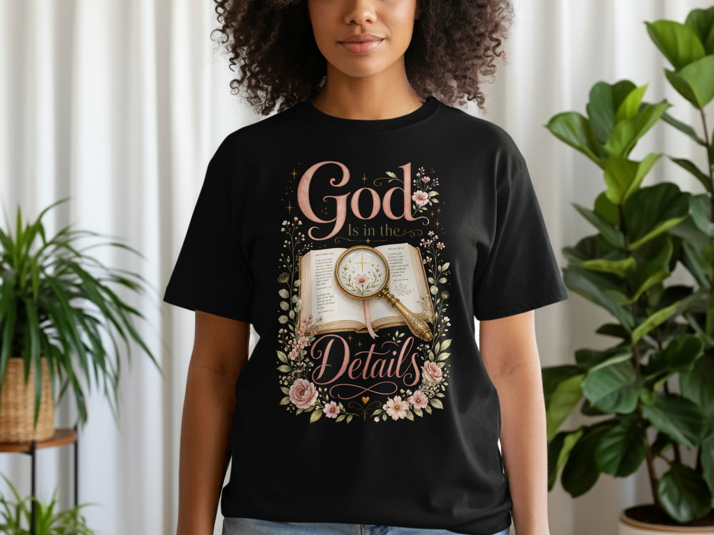 Black t-shirt with "God Is in the Details" floral design and Bible verses.