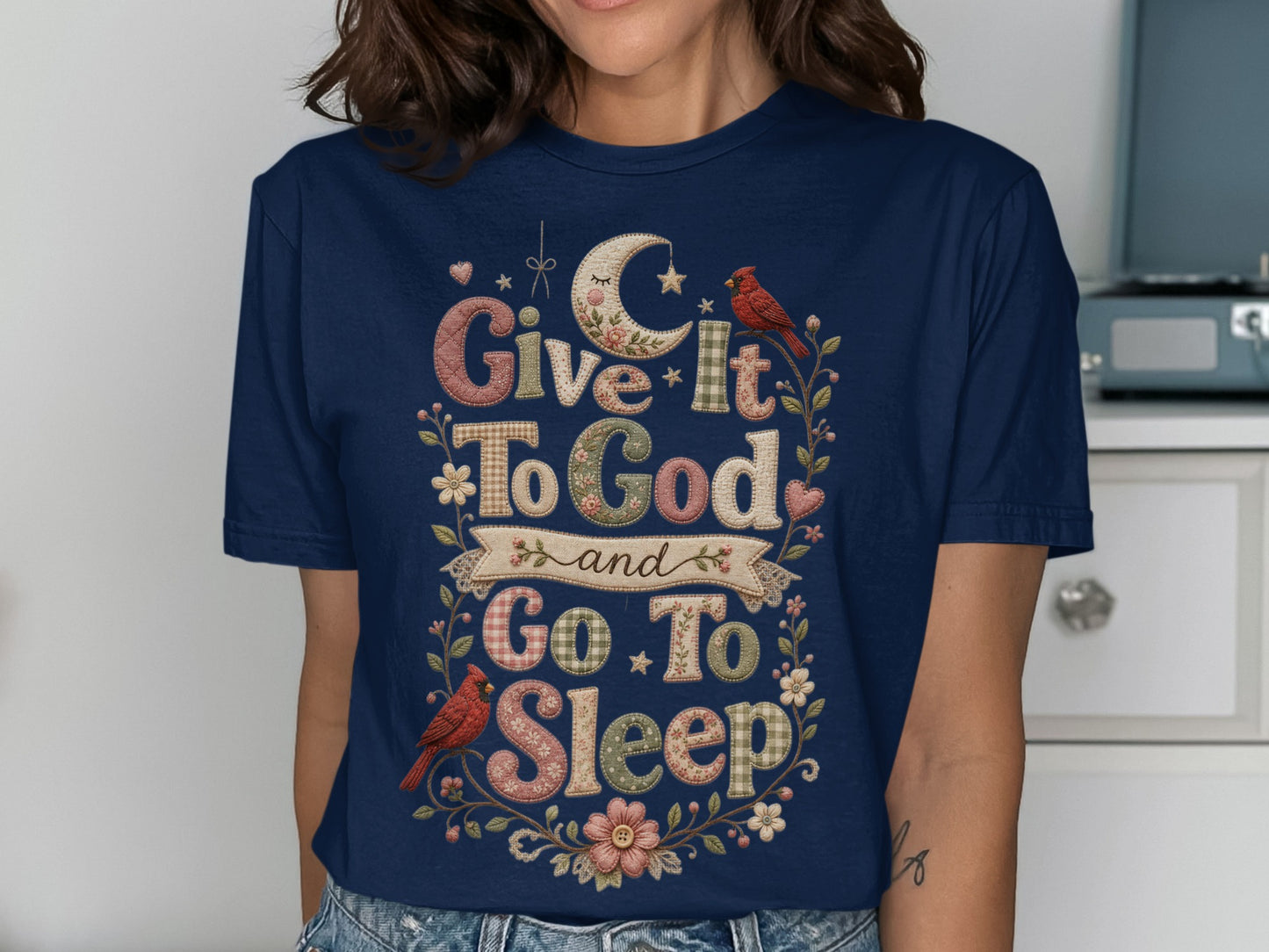 Navy t-shirt with "Give it to God and Go to Sleep" text and bird embellishments.