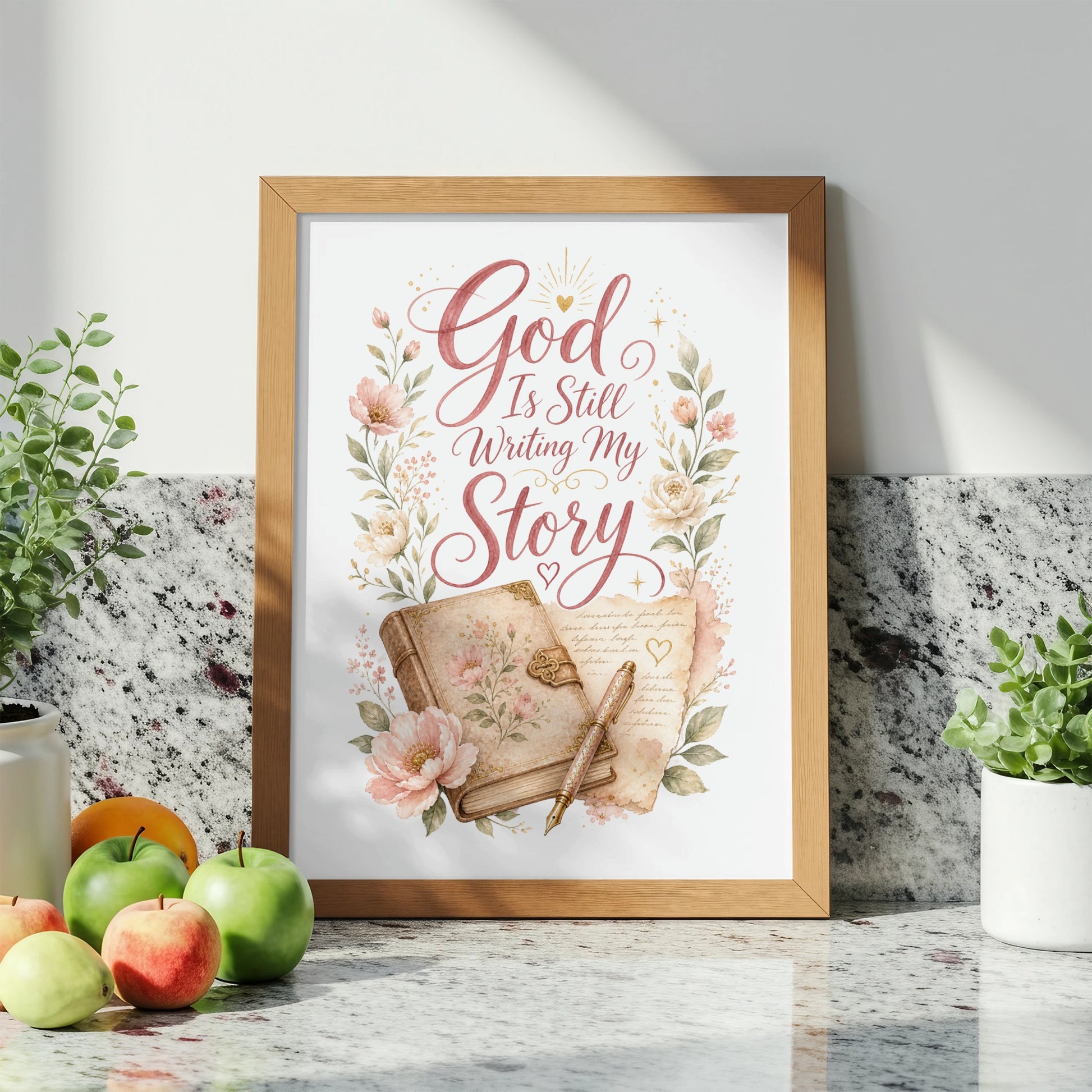 Framed artwork with "God Is Still Writing My Story" text, antique book, and pen.