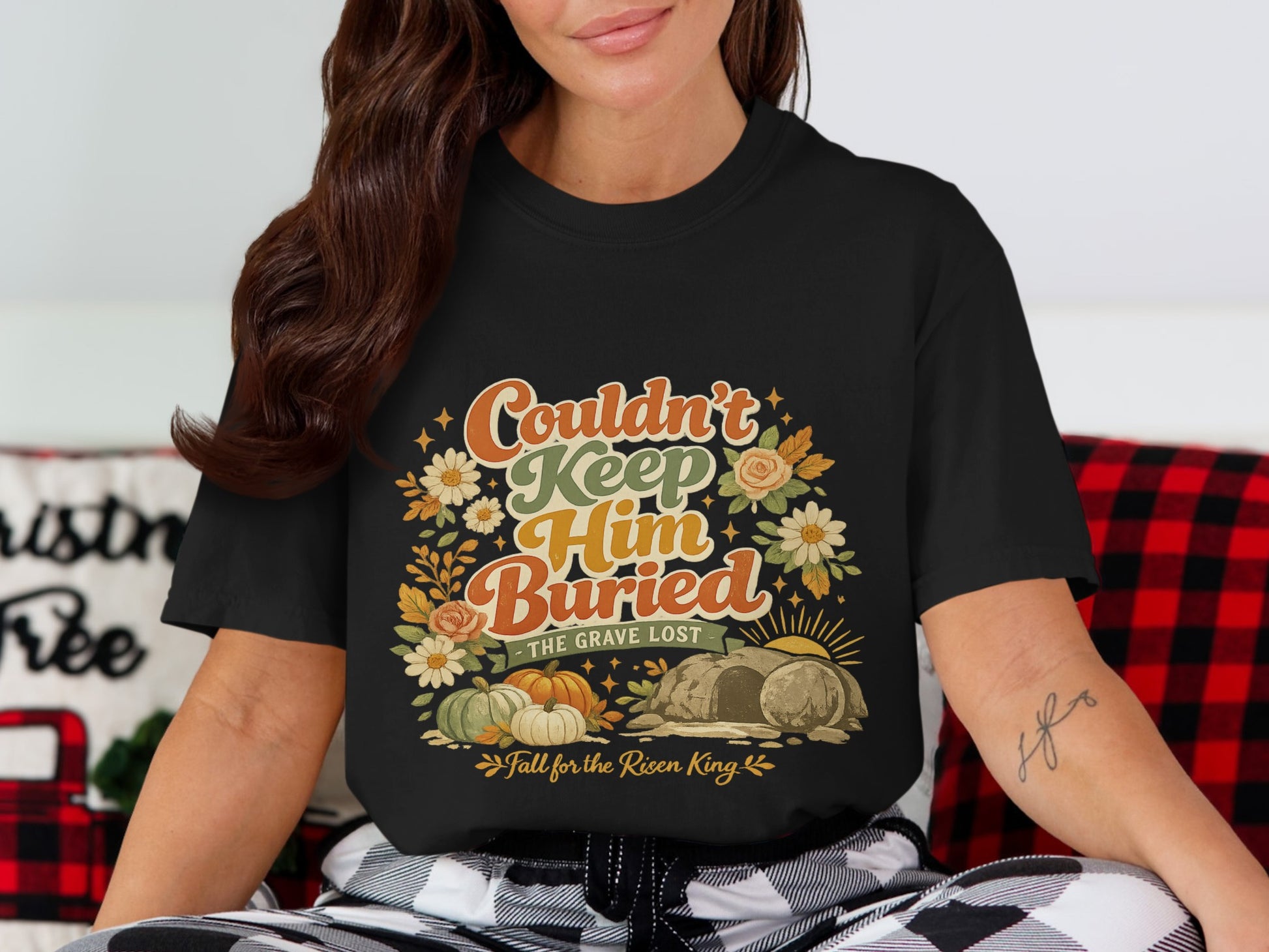 Black t-shirt with "Couldn't Keep Him Buried" graphic featuring pumpkins, flowers, and a tomb.