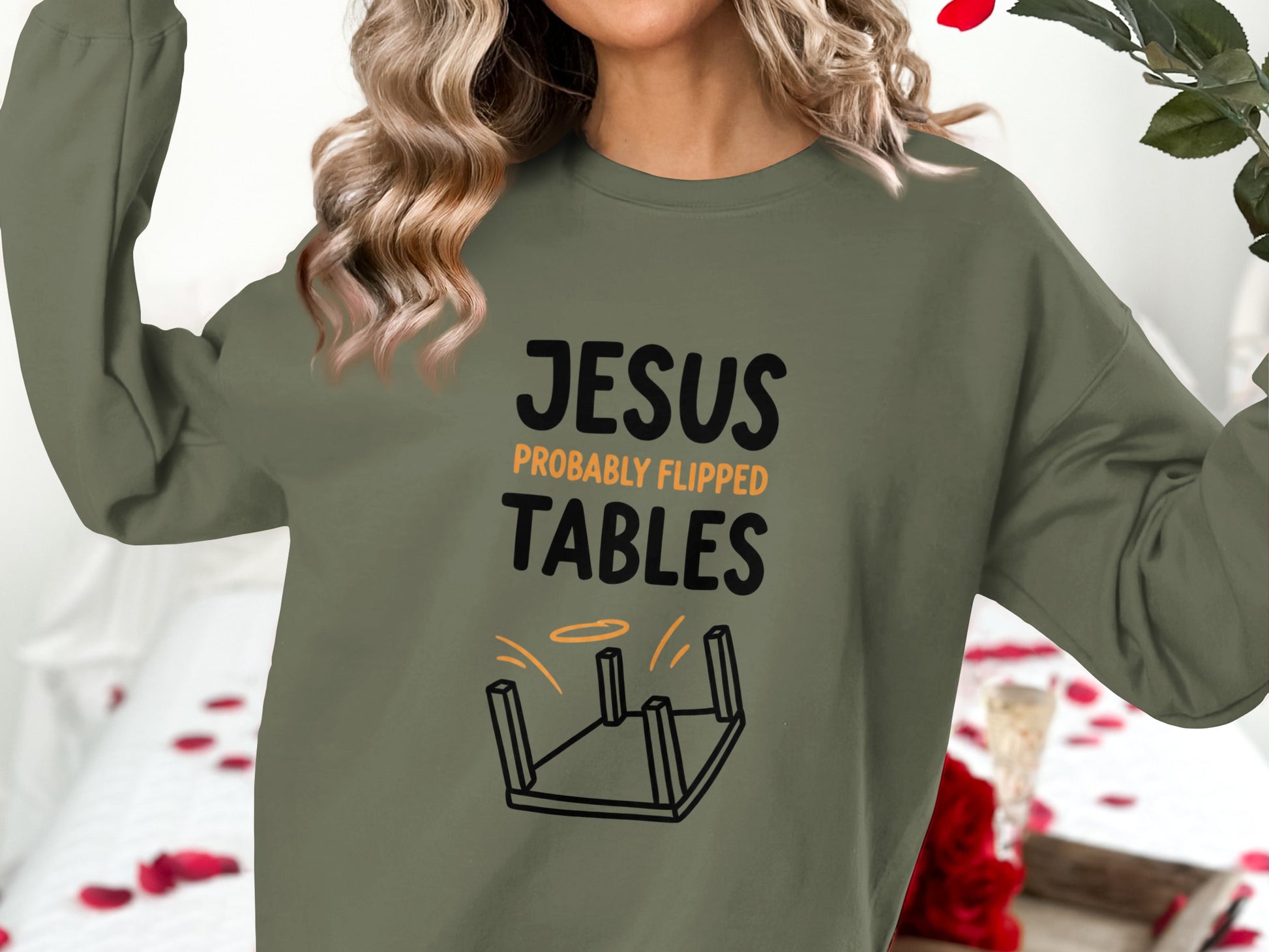 Olive green sweatshirt with "Jesus Probably Flipped Tables" text and overturned table graphic.