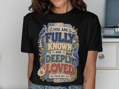 Black t-shirt with "You are fully known and deeply loved" text and blue birds.