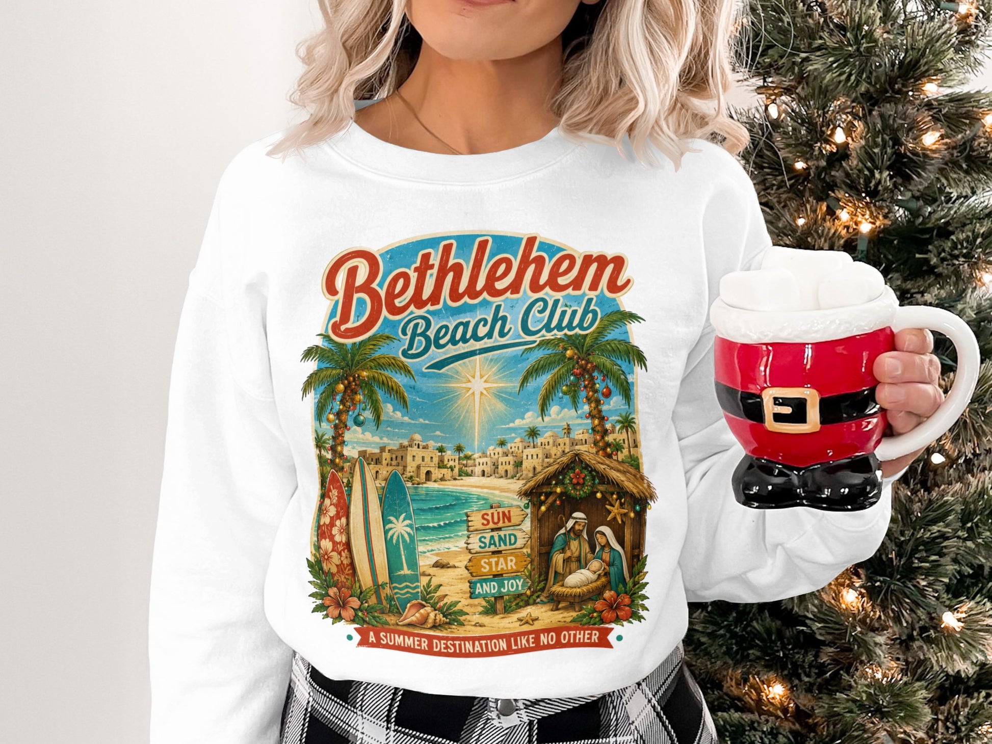 Bethlehem Beach Club sweatshirt with nativity scene and Santa mug.