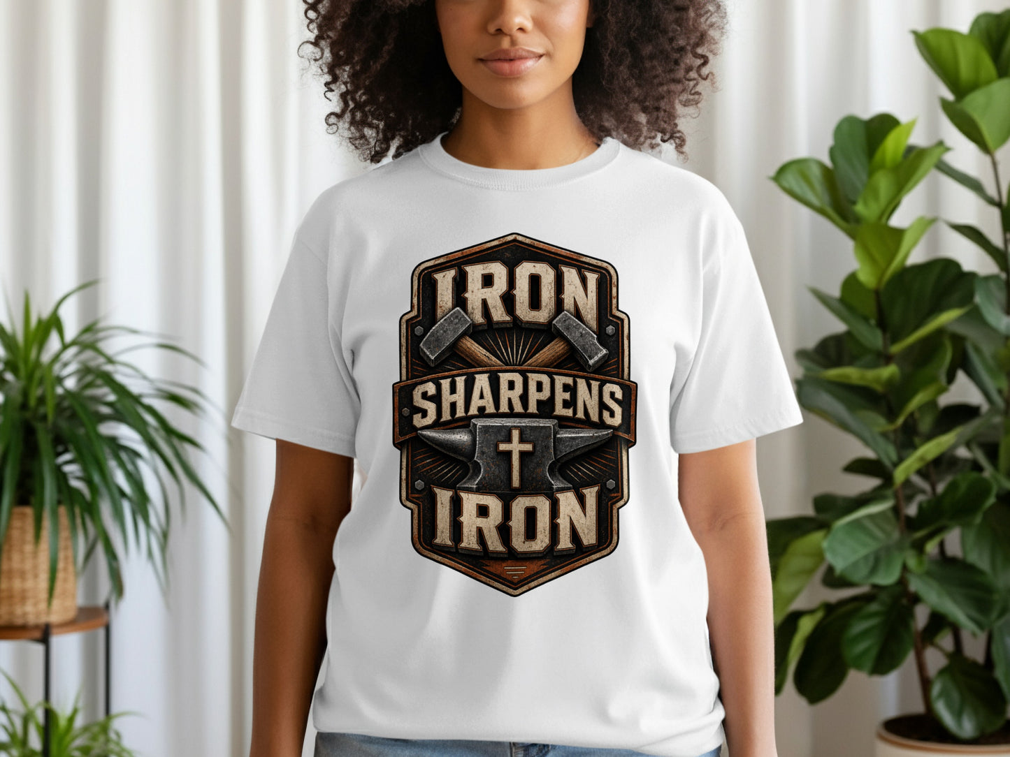 White t-shirt with a shield logo featuring hammers, anvil, cross, and text.