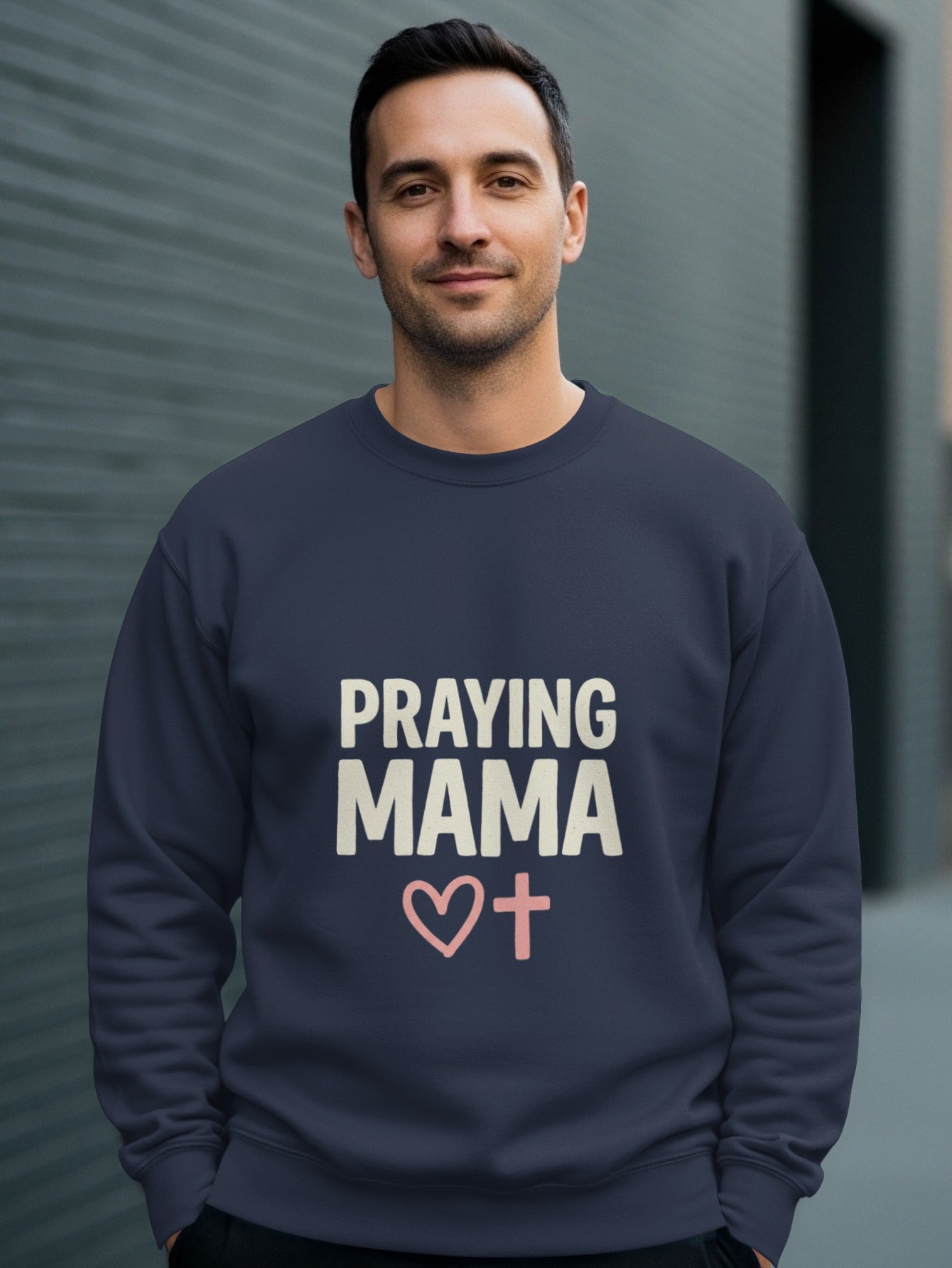 Navy sweatshirt with "Praying Mama" text and a pink heart with a cross.