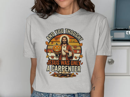 Jesus holding a jack-o'-lantern with "Jesus was only a carpenter" text.