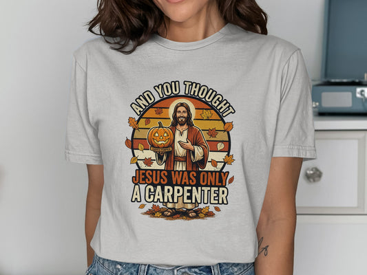 Jesus holding a jack-o'-lantern with "Jesus was only a carpenter" text.