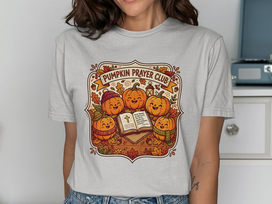 Pumpkin Prayer Club t-shirt with smiling pumpkins reading a Bible.