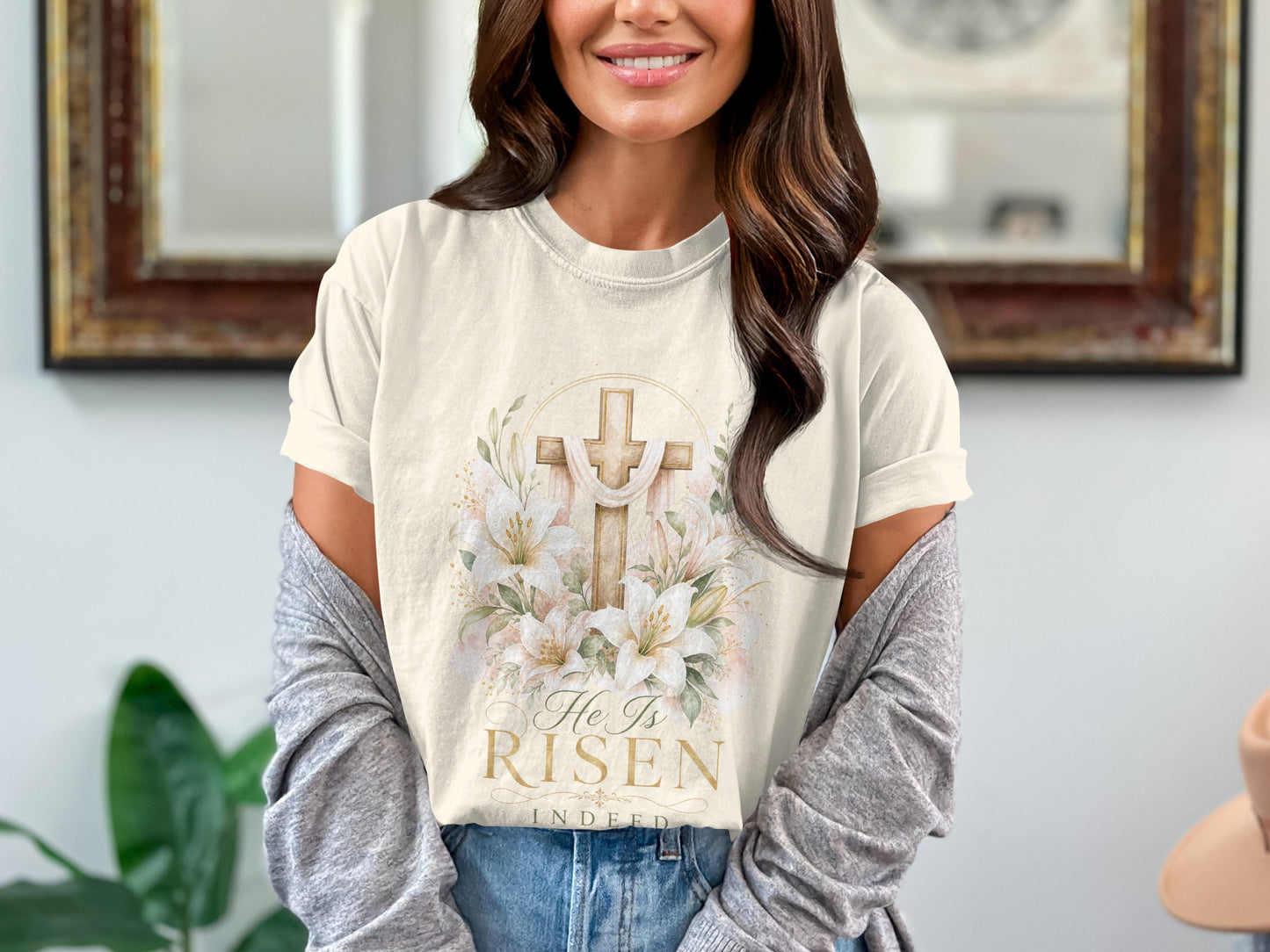 Ecru t-shirt with a wooden cross, lilies, and text "He Is Risen Indeed".