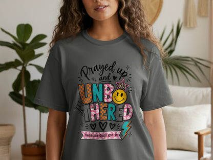 Gray t-shirt with "Prayed up and UNBOTHERED because God's got it" text.