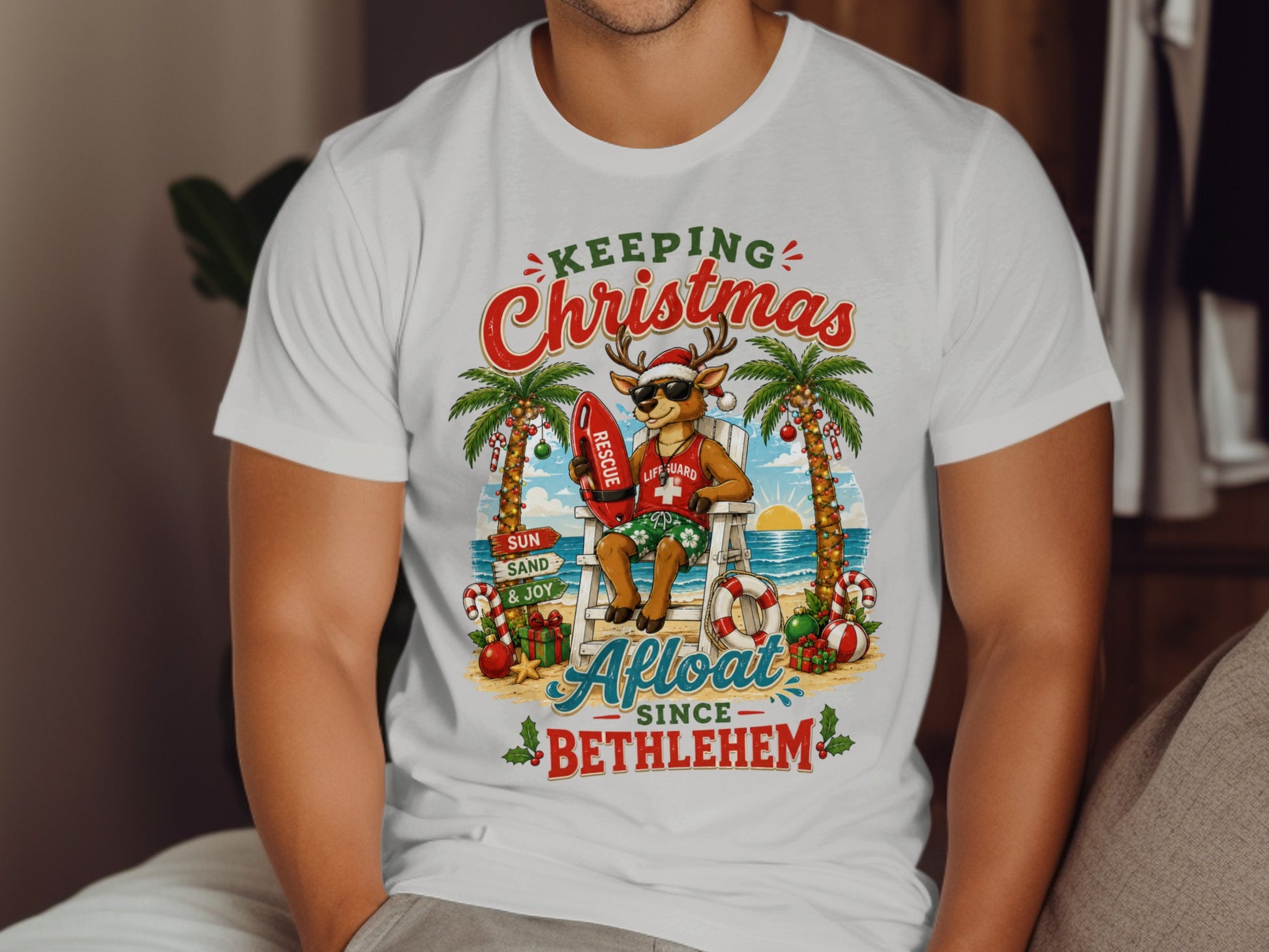 Santa deer lifeguard on beach chair with "Keeping Christmas Afloat Since Bethlehem" text.