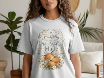 White t-shirt with a floral wreath framing a sleeping fox and the text "Fearfully and Wonderfully Made."