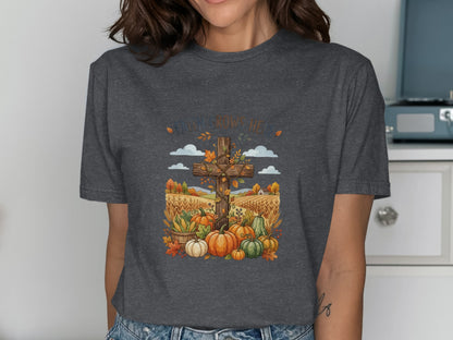 T-shirt with a cross, pumpkins, and autumn leaves, saying "Faith Grows Here."