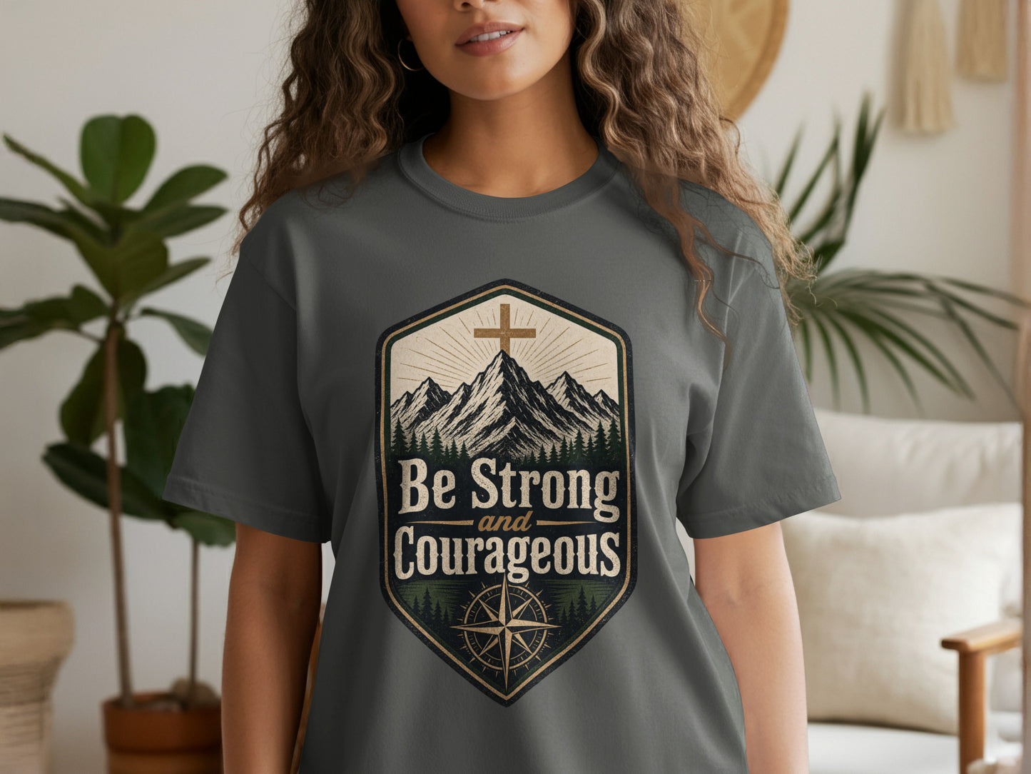 Grey t-shirt with "Be Strong and Courageous" text and mountain cross design.