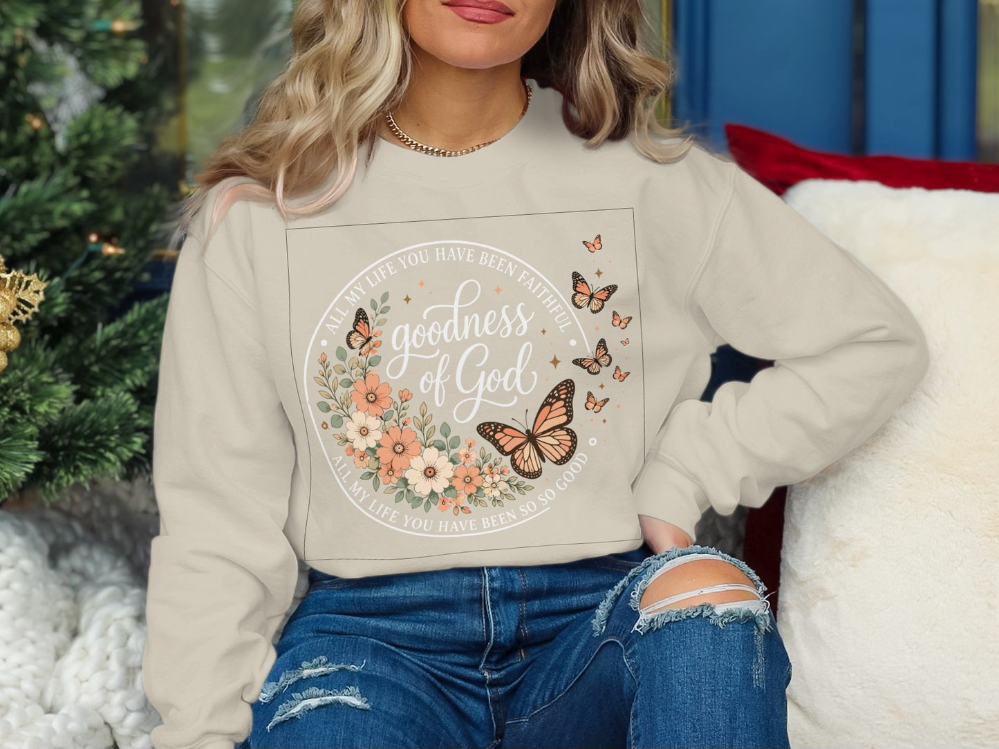 Cream sweatshirt with "goodness of God" and floral butterfly design.