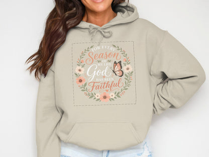 Light beige hoodie with floral circle and butterfly graphic reading "For every season of my life, God has been faithful."