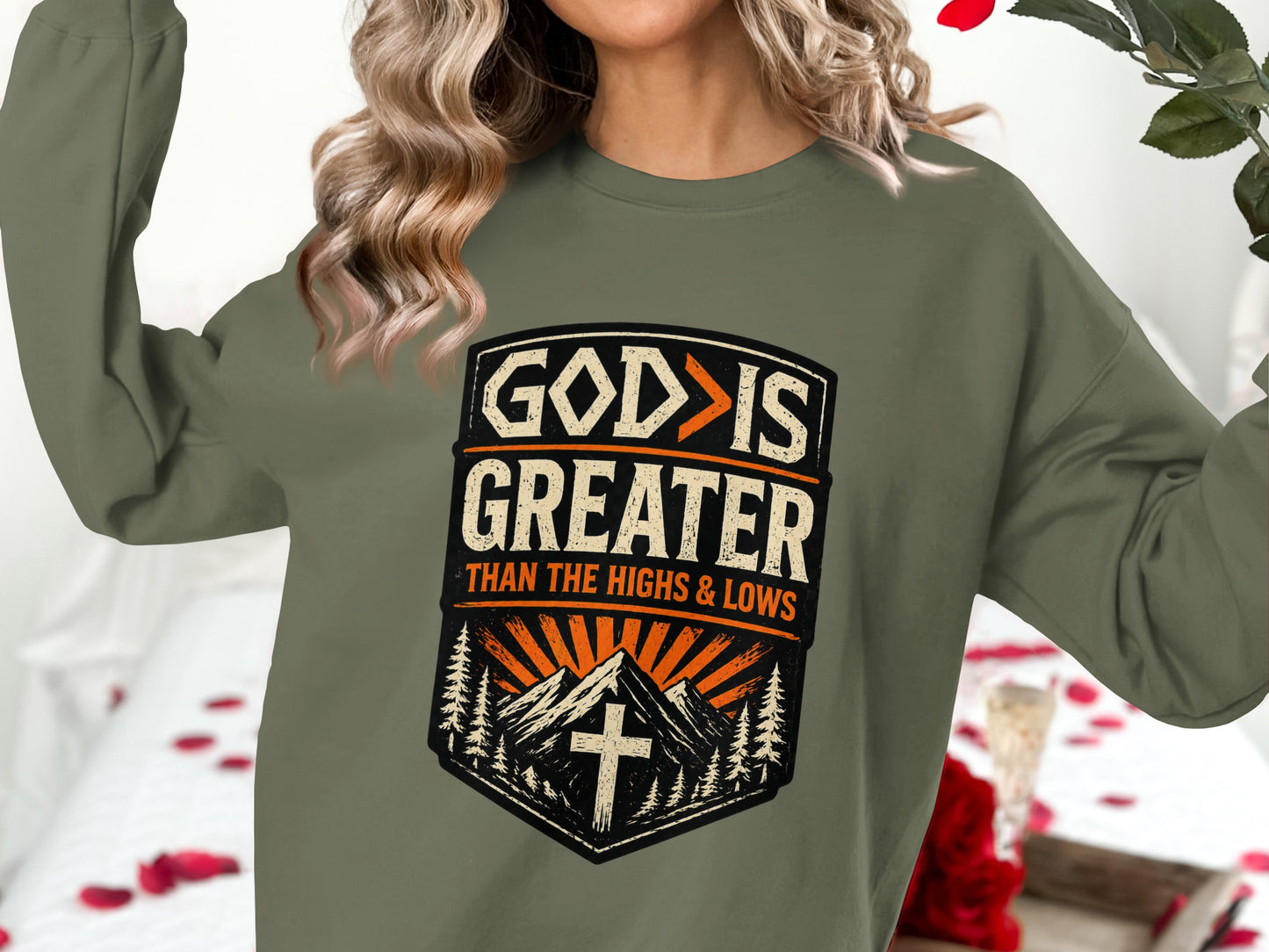 Olive green sweatshirt with "God is Greater Than The Highs and Lows" text.