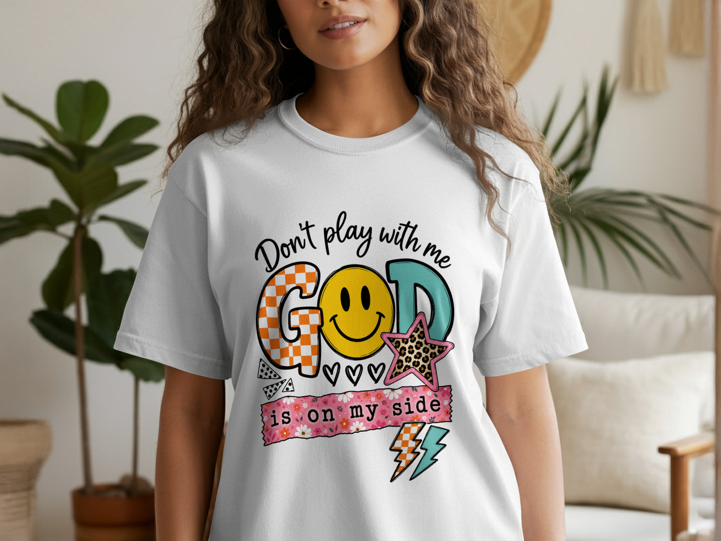 White t-shirt with "Don't play with me GOD IS ON MY SIDE" text and graphics.