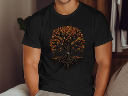 Black t-shirt with a colorful tree and cross graphic saying "Rooted in Christ".
