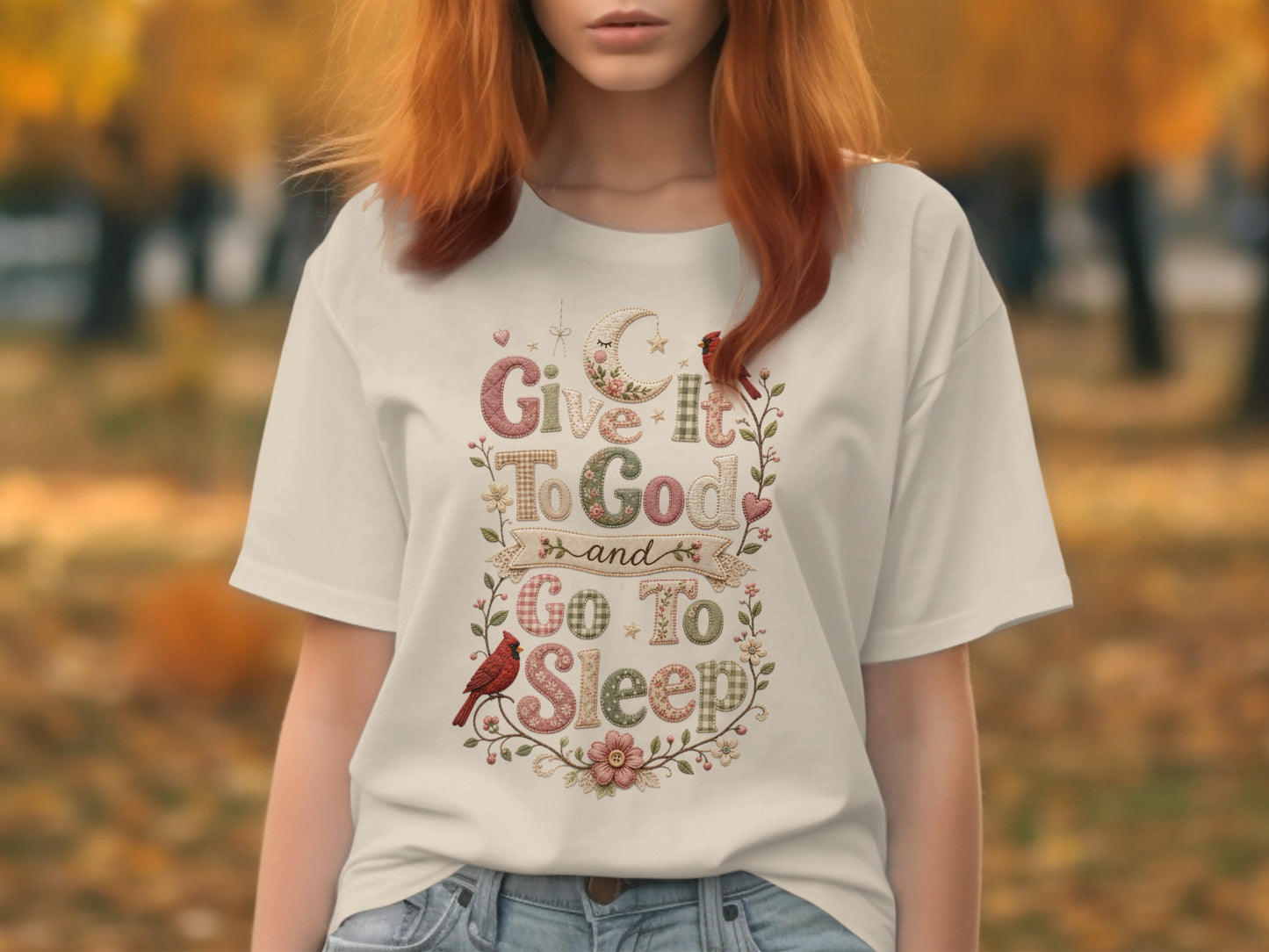 "Give It to God and Go to Sleep" text on a t-shirt with cardinals and floral embellishments.